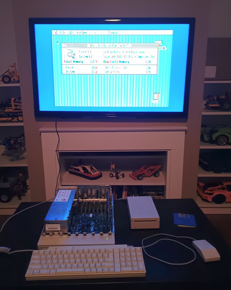 Television showing the about dialog from System 6.0 running on an Apple IIGS, which is set up on the table in front of the television