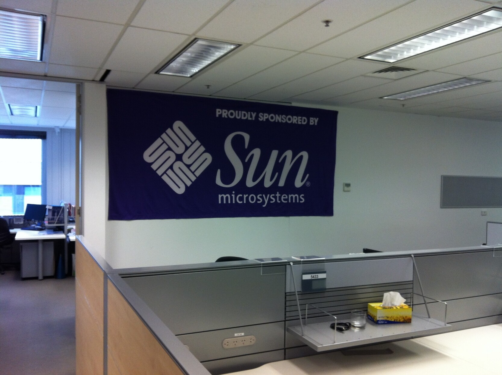 Sun Microsystems flag hanging in a standard office