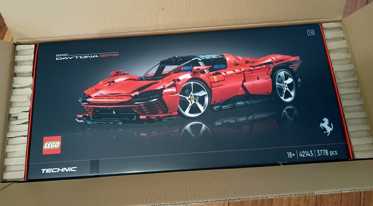 LEGO set 42143 Ferrari Daytona SP3 in its box within a shipping box