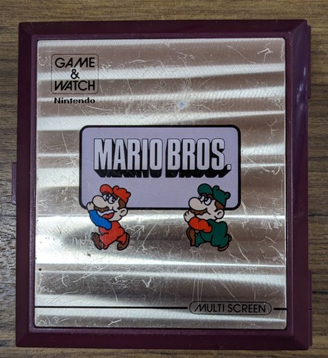 Nintendo Game & Watch Multi Screen Mario Bros handheld game front cover featuring the first sighting of Mario in Red and Luigi in green