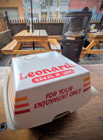A cardboard burger box with the Leonard's branding.