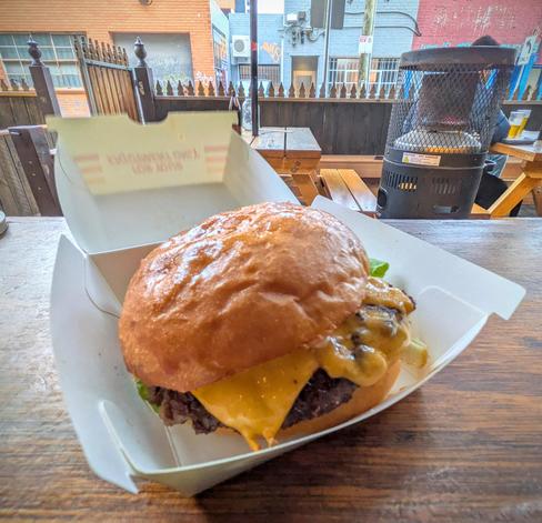The cheeseburger in the box in all it's glossy, greasy glory.