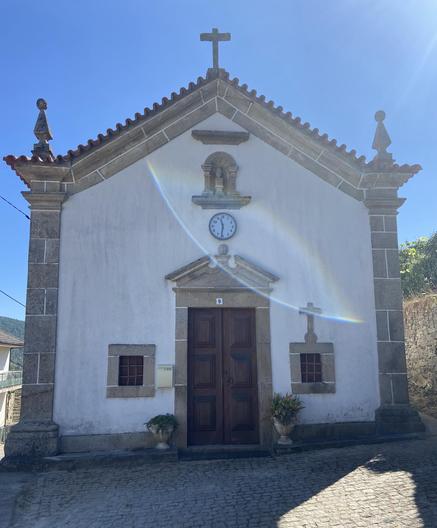 An old church with a modern clock attached to its facade.