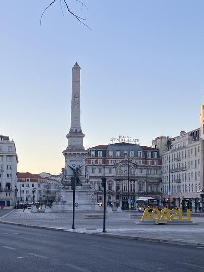 A column in a plaza under blue skies 