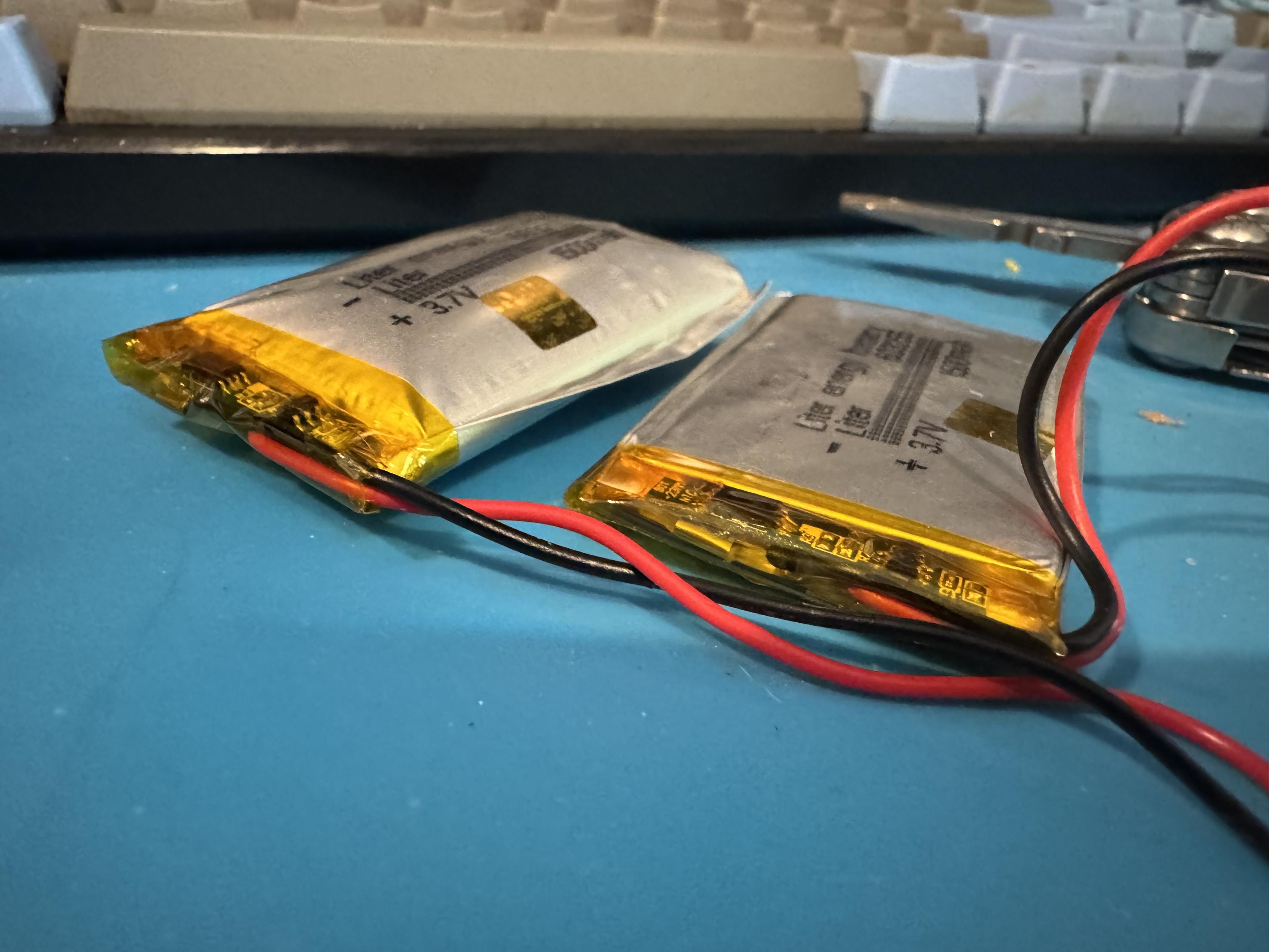 Two LiPo pouch batteries, one is very inflated compared to the other. 