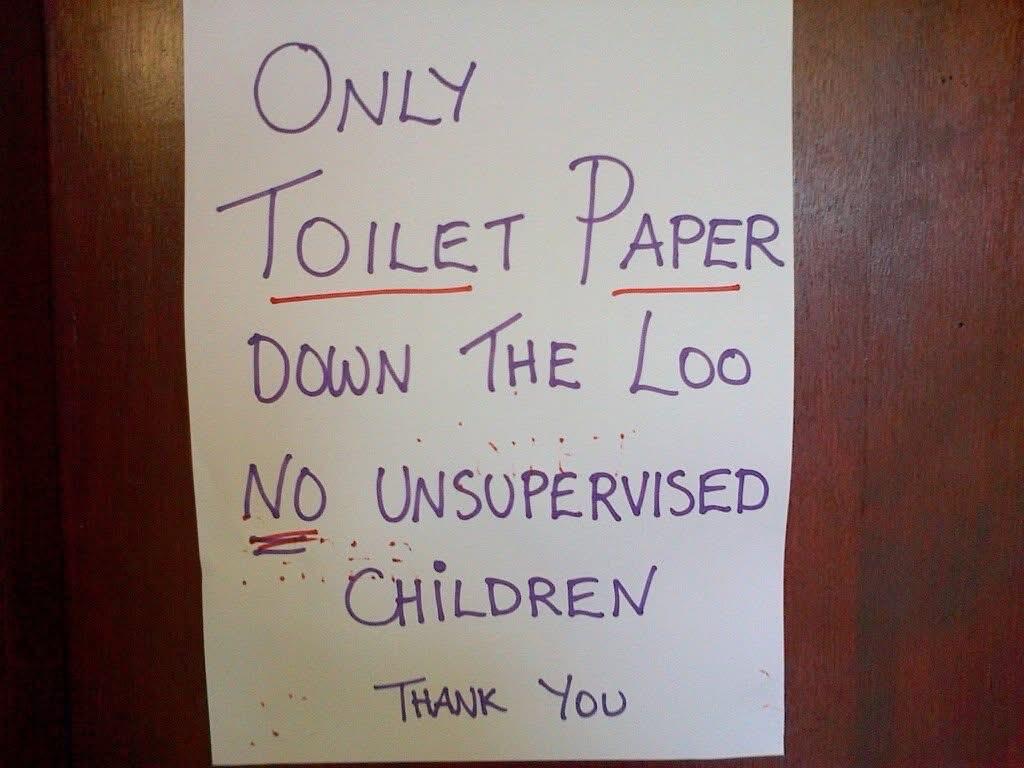 Handwritten paper sign taped to a wall reads:
ONLY TOILET PAPER DOWN THE LOO 
NO UNSUPERVISED CHILDREN 
THANK YOU 