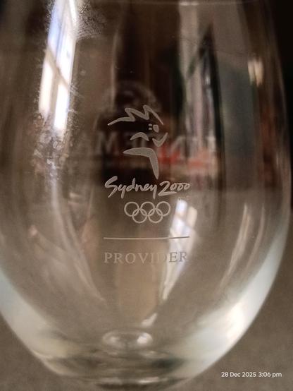 Other side of the wine glass with the Sydney 2000 logo and Provider etched underneath.