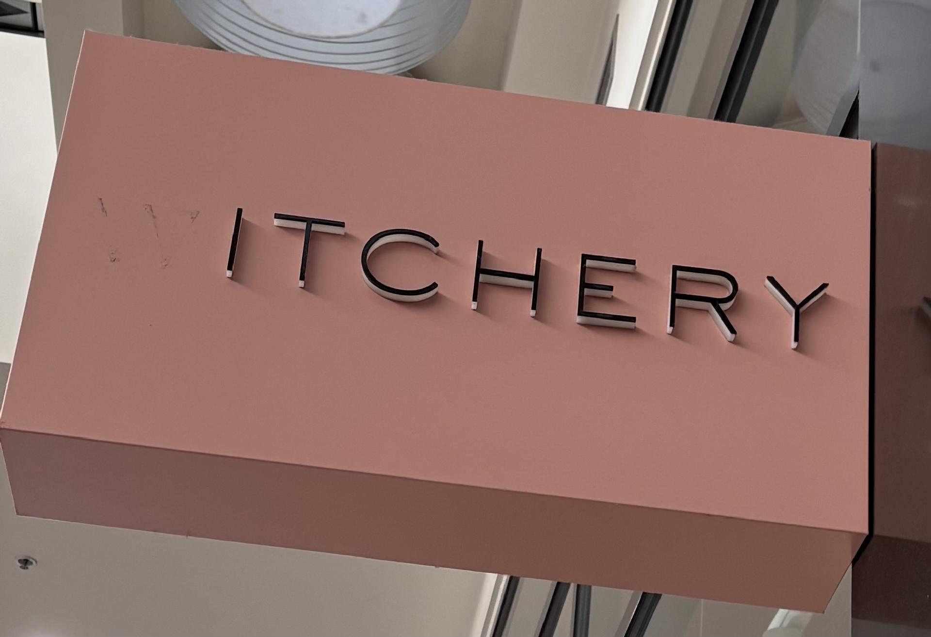 A sign for clothing store "Witchery", but the W fell off.