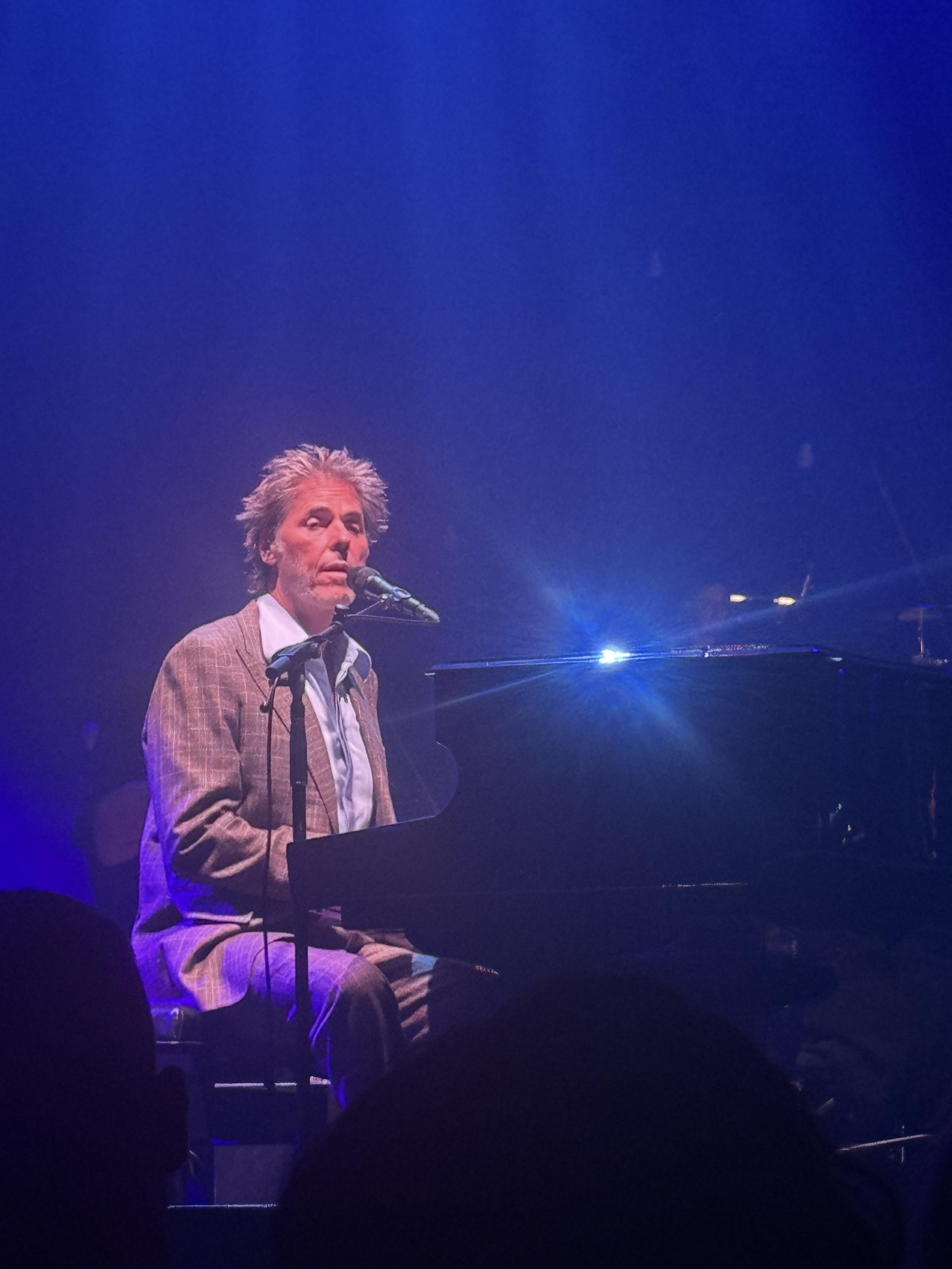 Tim Freedman sitting at a piano
