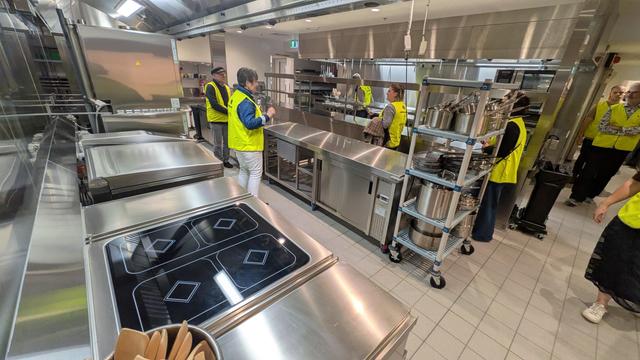 The new kitchen facilities with lots of shiny new stainless steel equipment and benches all over the place. In the foreground are a new 4-burner induction cook top and a gigantic motorised bratt pan.