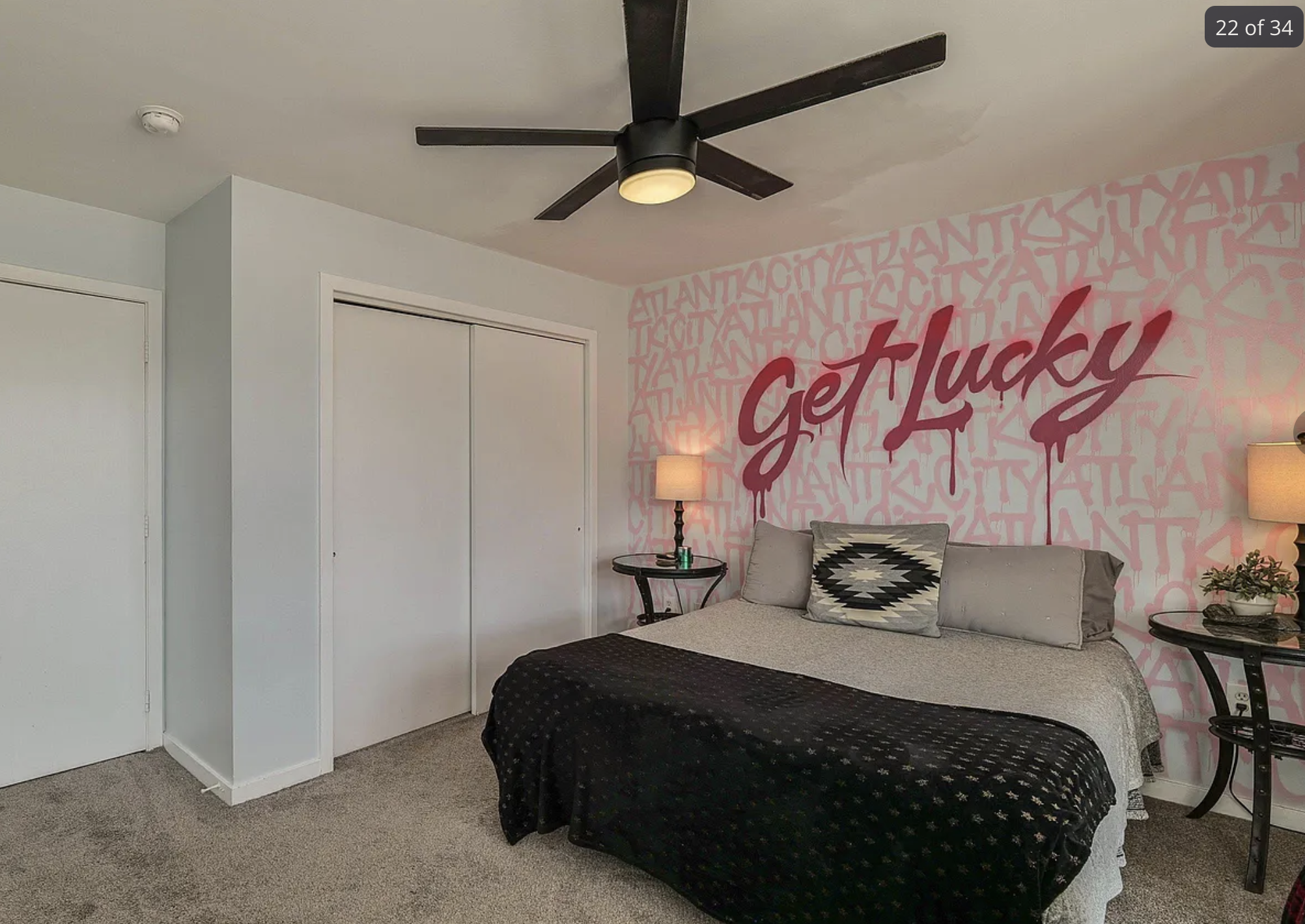 A bedroom with the words "get lucky" messily spray painted on the back wall