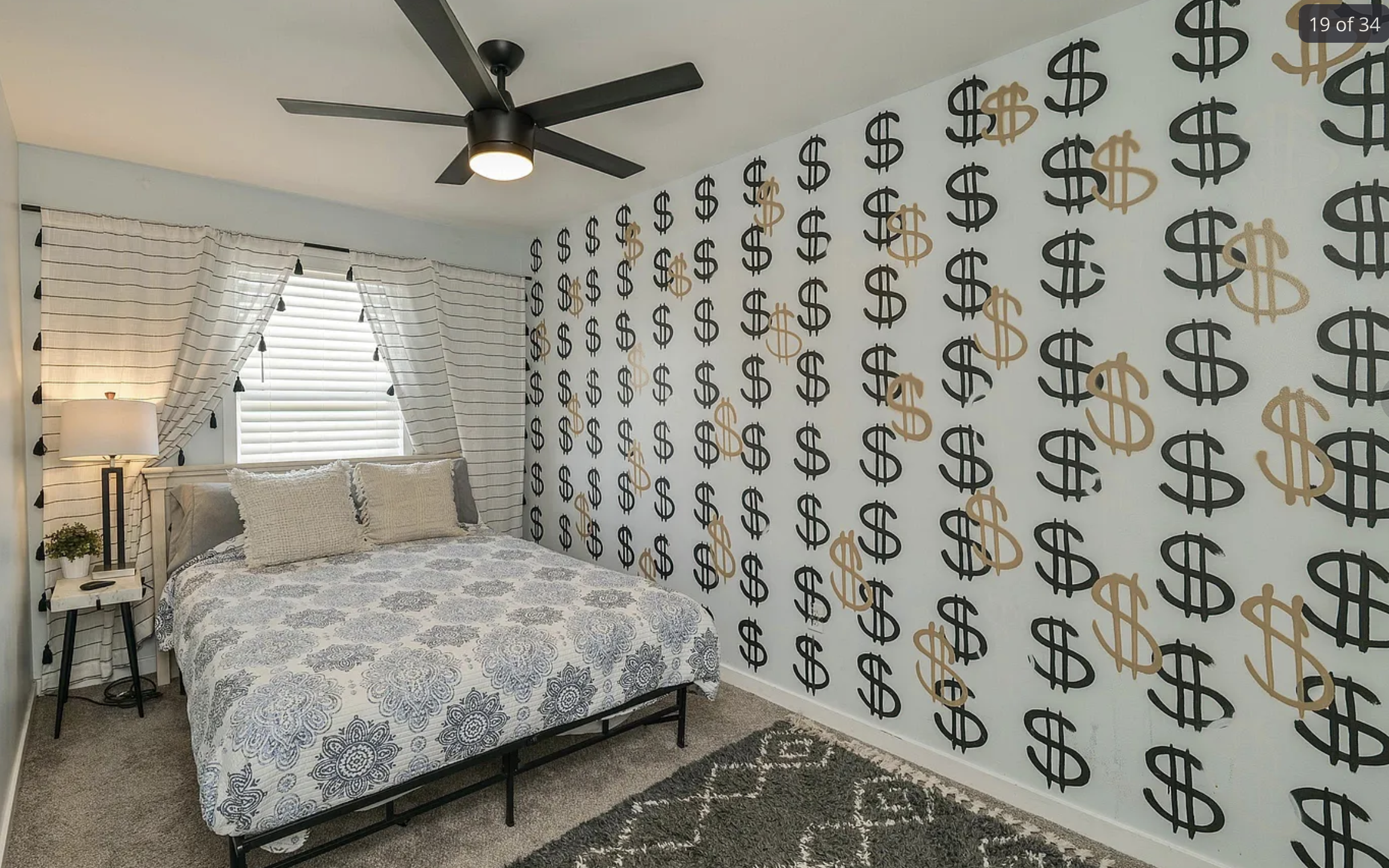 A bedroom with dollar signs spray painted all over the wall