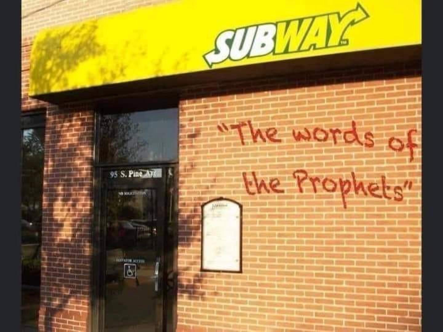 “The words of the prophets” written in red paint on the wall of a Subway store.