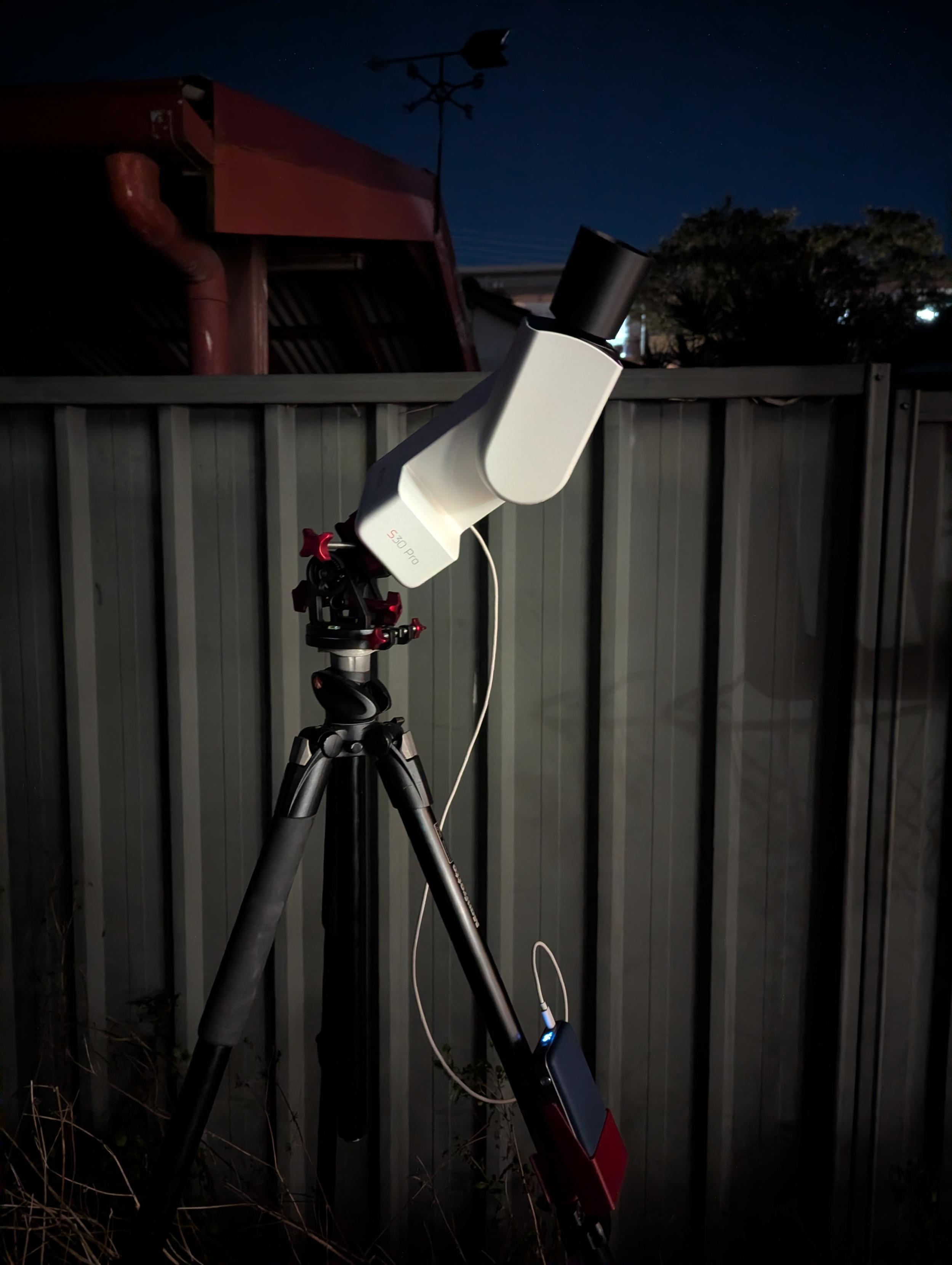 Photo of a smart telescope on a tripod.