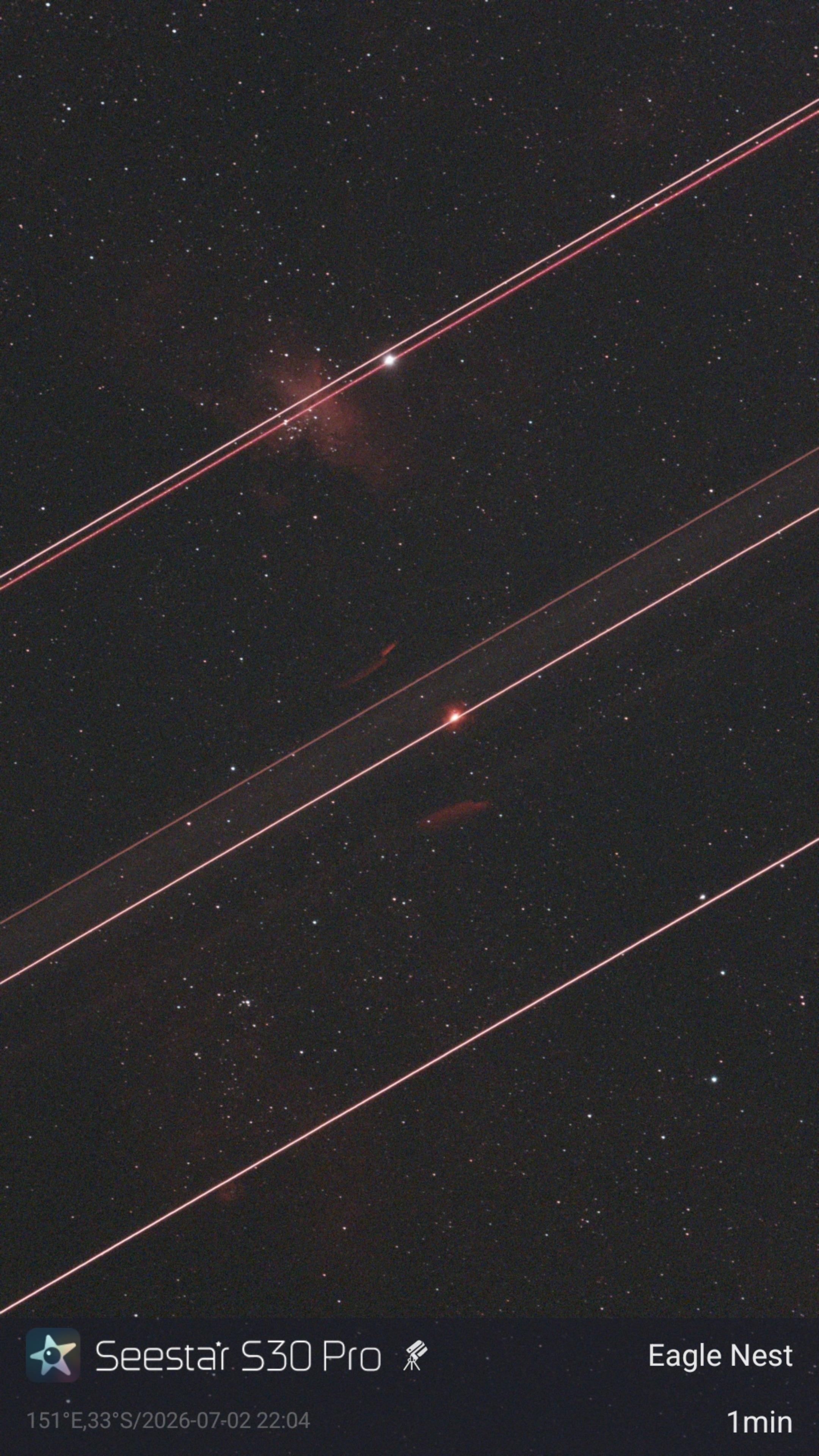 Image of the night sky with several parallel streaks running through it.