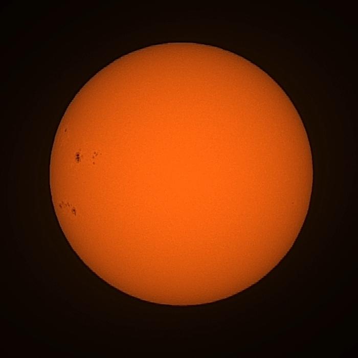 Image of the Sun from a Seestar S30 Pro smart telescope. Several large sunspots are visible towards the left edge of the Sun.