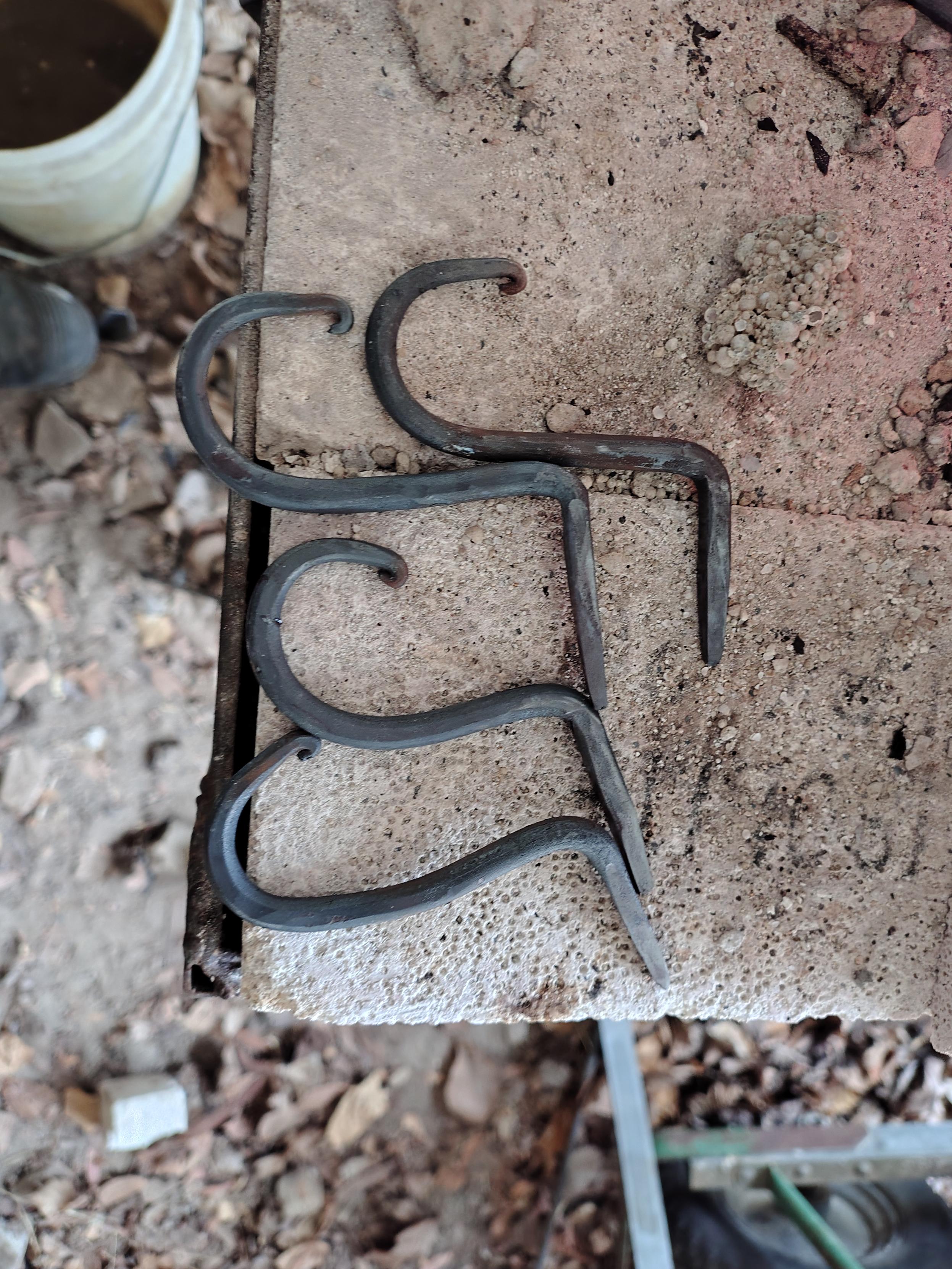4 forged steel hooks . Each one has a loop, with a spike coming back out of the top