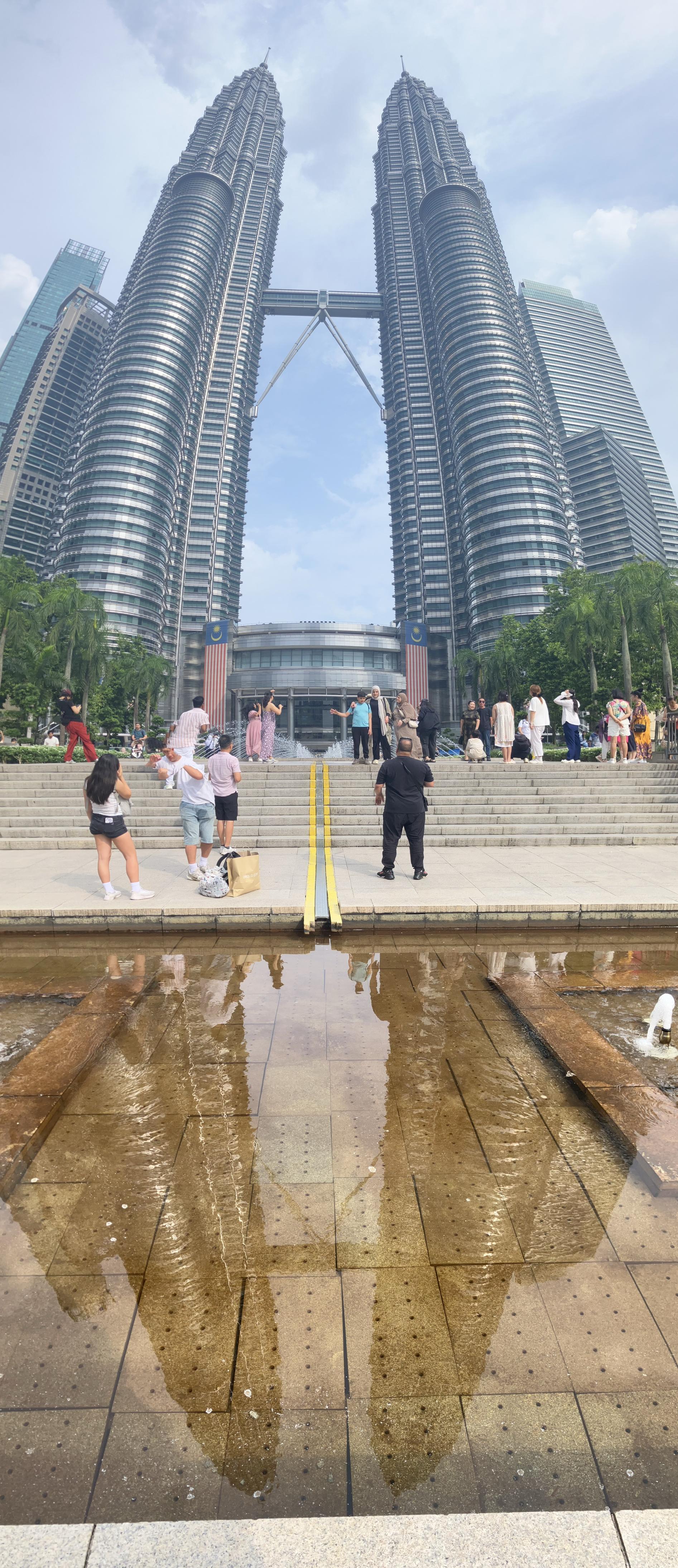 The Petronas towers reflected in a pond